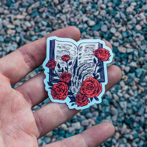 Bookish Sticker - Skeleton's Hand Holding a Book with Roses - Gothic Literary Decal for Bookworms